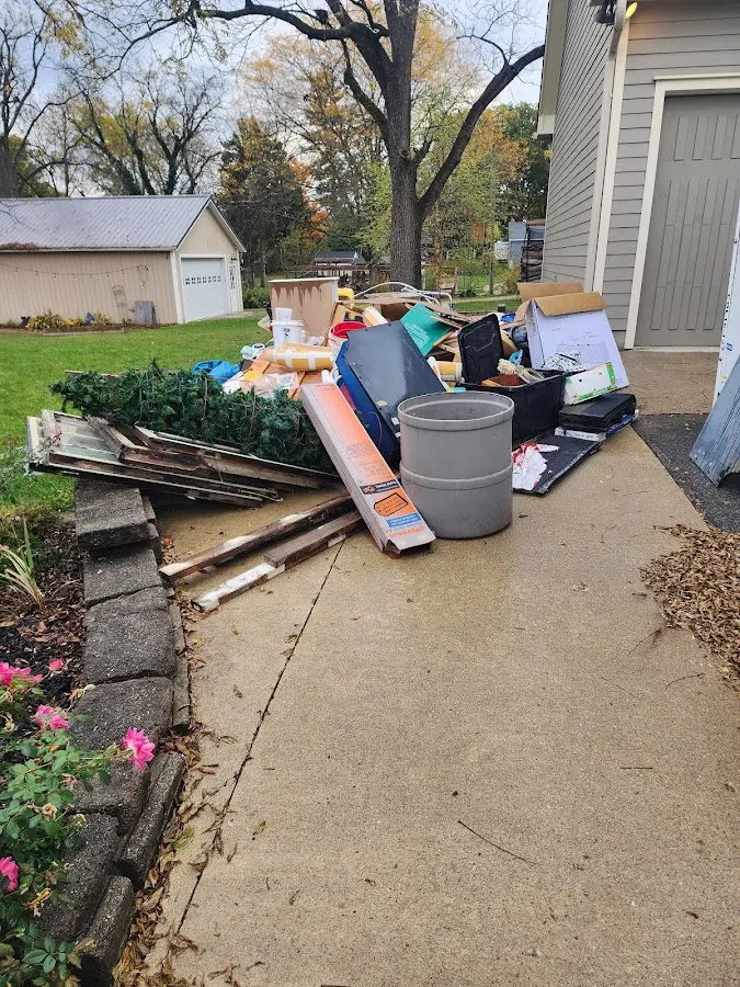 Dumpster being loaded with debris for 12 Yard Dumpster Rental in Keyser